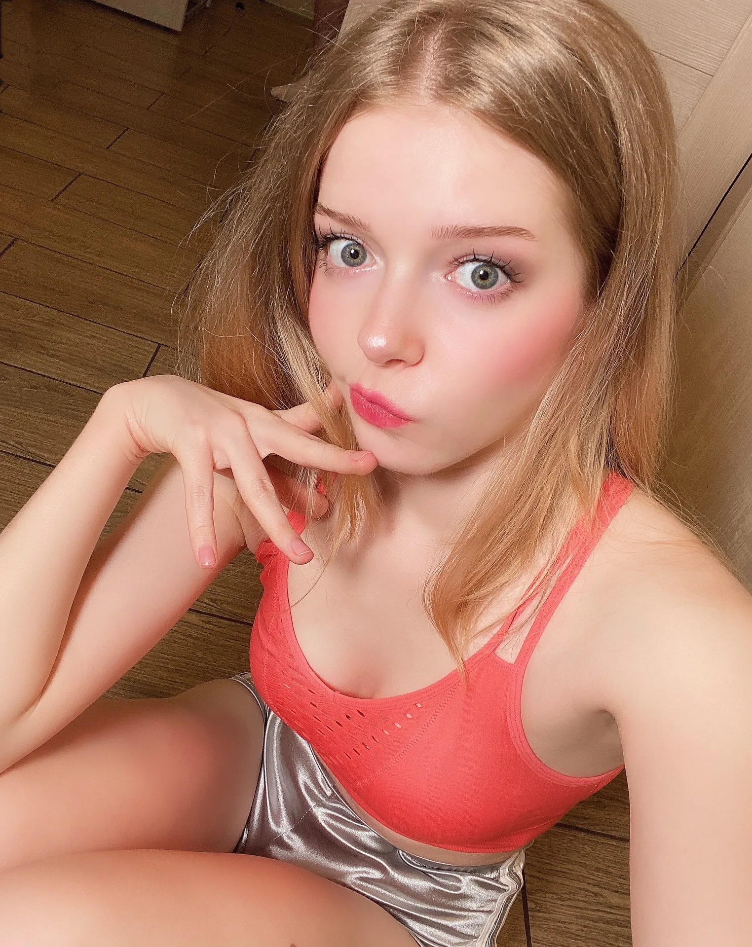 Coral top and silver shorts