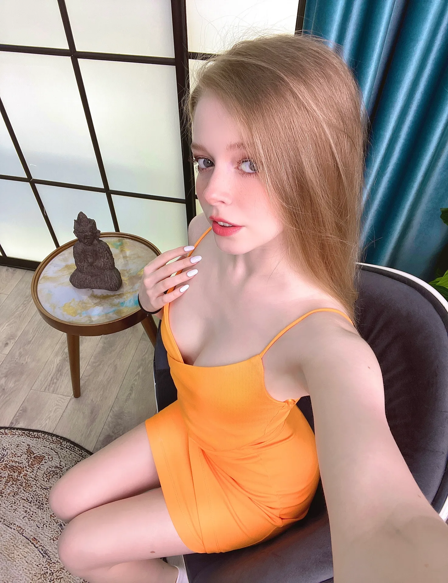 Orange dress in a black chair